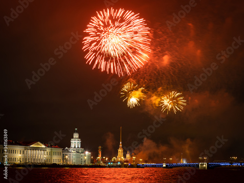 Saint Petersburg on a festive evening. Russia. Salute over the Neva. Salute volleys over Vasilievsky island and Peter and Paul fortress. Palace bridge on the background of fireworks.