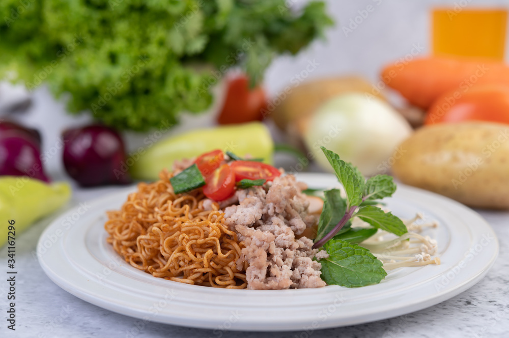 Stir-fried noodles with minced pork, edamame, tomatoes and mushrooms in a white plate. Stir-fried noodles with minced pork, edamame, tomatoes and mushrooms in a white plate.