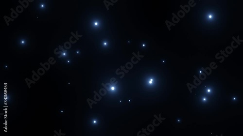 Light blue dust particle float on black background.