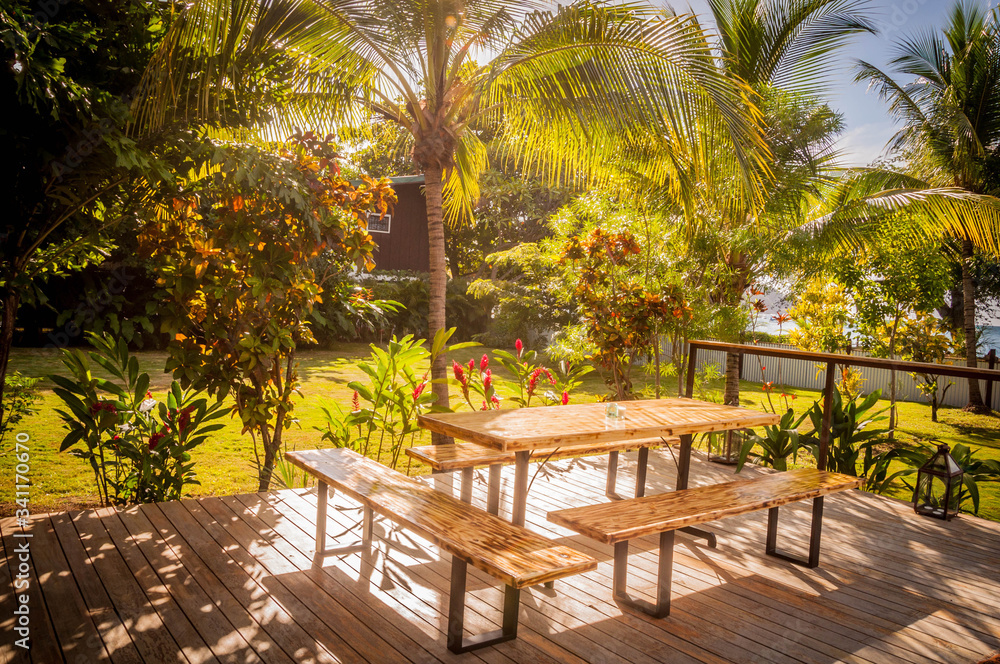 A wooden table on a green oceanview garden