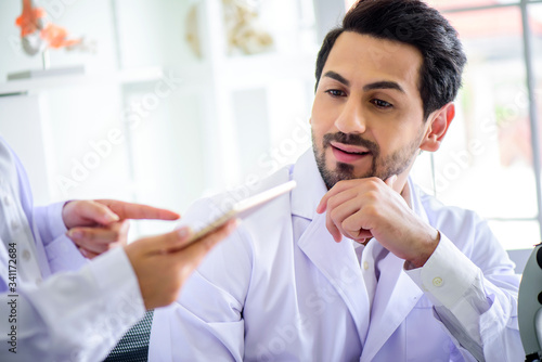 Attractive happiness scientist man lab technician assistant analyzing sample in test tube with microscope at laboratory. Medical, pharmaceutical and scientific research and development concept.