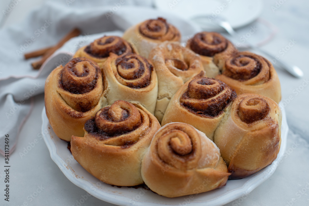 Cinnamon rolls with sugar frosting. With cinnamon sticks and spices Cinnamon rolls with sugar frosting. With cinnamon sticks and spices