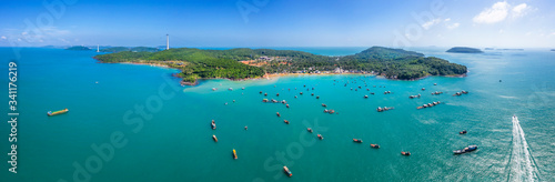 Aerial view of white sand beach and boat on the blue lagoon aqua sea. Royalty...