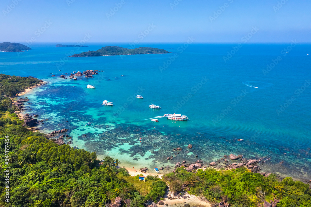 Aerial view of people swimming on the sea and beach on Gam Ghi Phu Quoc island in Thailand bay, Kien Giang, Vietnam. Aerial view of people swimming on the sea and beach on Gam Ghi Phu Quoc island in Thailand bay, Kien Giang, Vietnam.