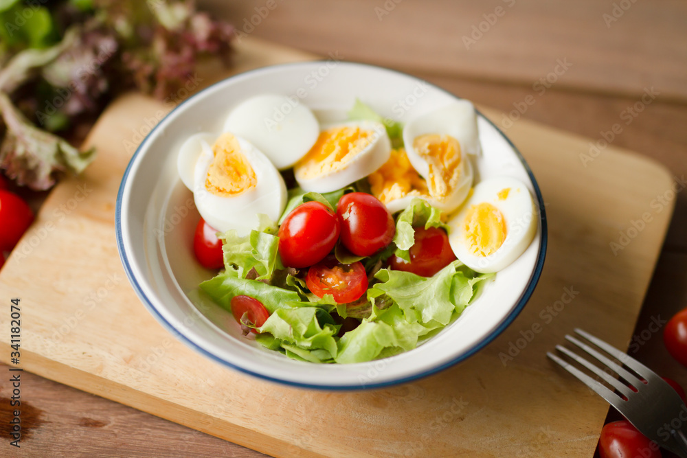 Delicious Breakfast of Egg salad with fresh tomato put on block chop at the kitchen. Healthy eating and Diet food concept. Delicious Breakfast of Egg salad with fresh tomato put on block chop at the kitchen. Healthy eating and Diet food concept.