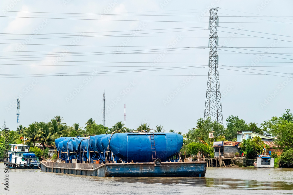 Boat transporting cement on the Mekong River. Vinh Long, Vietnam, Mekong delta.