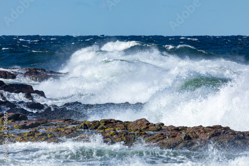 Fototapeta Spring gale wave hitting the shore