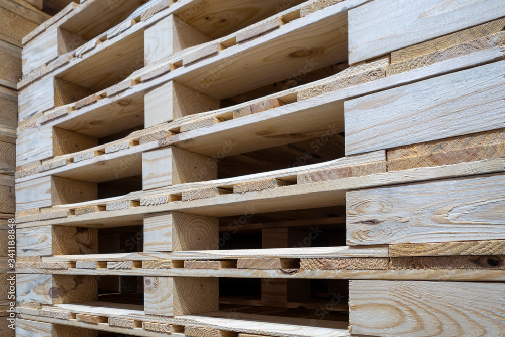 stack of wooden pallets inside a warehouse stack of wooden pallets inside a warehouse
