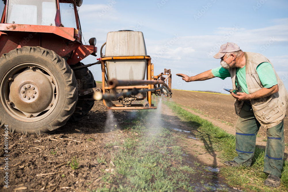 farmer controls the operation of the sprayer. agronomist uses modern technology in his fields. the farmer uses the tablet during field work farmer controls the operation of the sprayer. agronomist uses modern technology in his fields. the farmer uses the tablet during field work