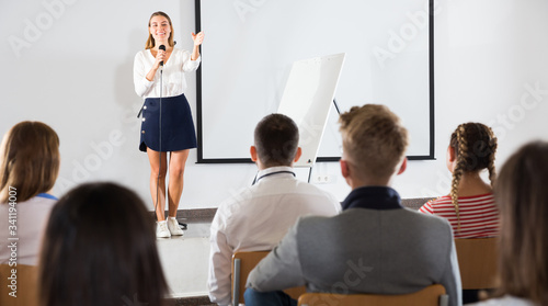 Female coach giving presentation for audience