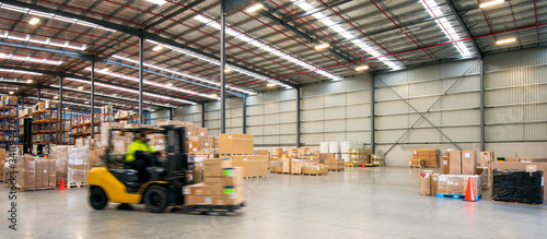 Forklift working at logistics warehouse photo