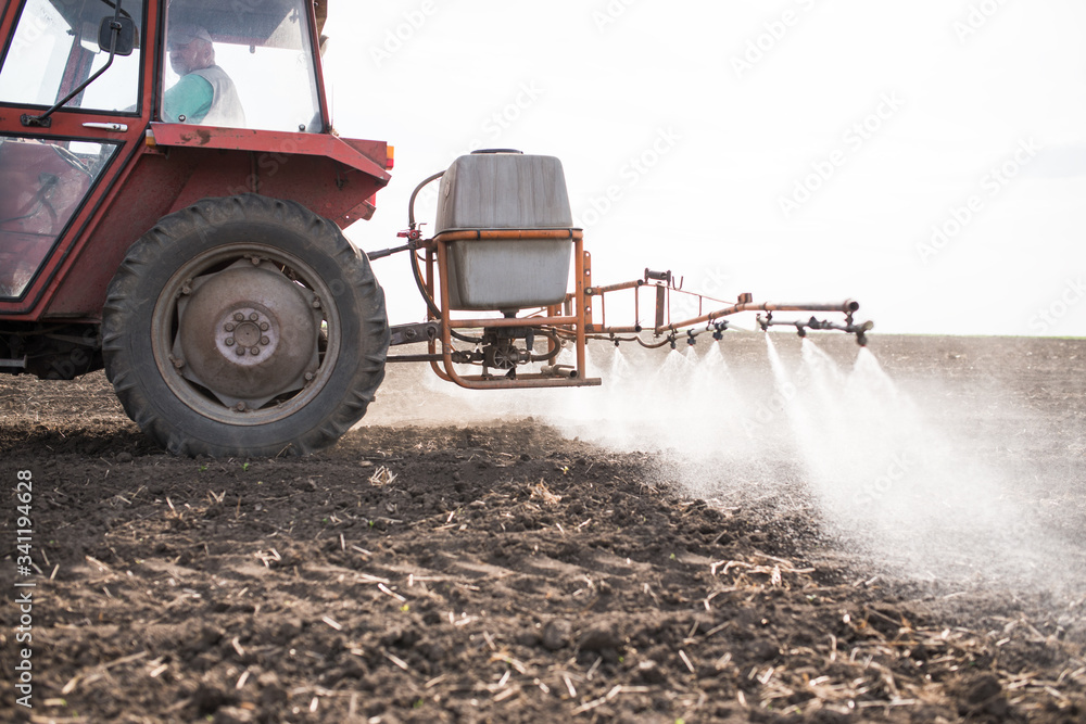 Obraz premium Agricultural sprayers, spray chemicals on field. spraying pesticides on field with sprayer