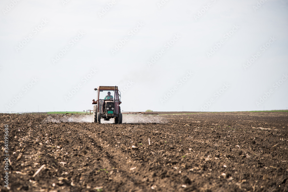 tractor spraying sunflower field before sprouting. treating the soil with chemistry. tractor spraying sunflower field before sprouting. treating the soil with chemistry.