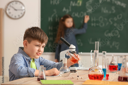 Cute little boy at chemistr...