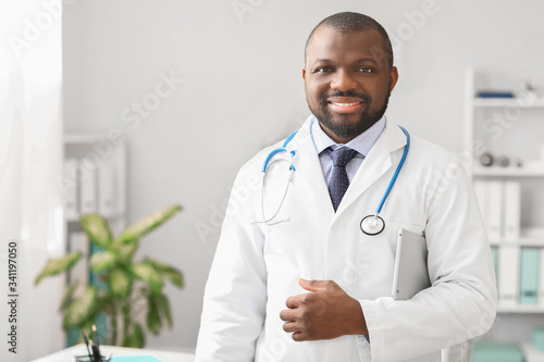 Male African-American doctor with tablet computer in clinic