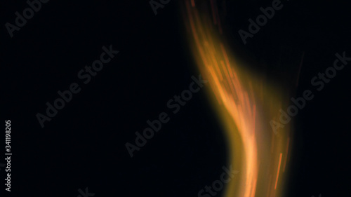 Macro photo of Bonfire sparks. Fire Flames bursts, blasts. Explosion micro sparkles. Mini Fireworks. Shooting on Red camera still on black background. Spark poster, banner, wallpaper, texture. © vjtar