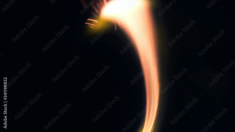 Macro photo of Bonfire sparks. Fire Flames bursts, blasts. Explosion micro sparkles. Mini Fireworks. Shooting on Red camera still on black background. Spark poster, banner, wallpaper, texture.