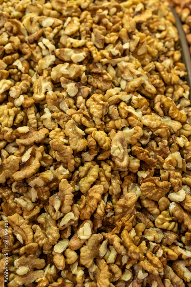 Background made of nuts. Peeled walnuts in the market. Healthy, wholesome food. Organic products. Source of vitamins and minerals. Grocery market in Georgia. Background made of nuts. Peeled walnuts in the market. Healthy, wholesome food. Organic products. Source of vitamins and minerals. Grocery market in Georgia.
