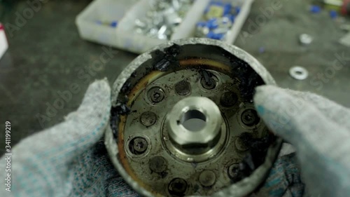 man rotating broken car ball bearings housing