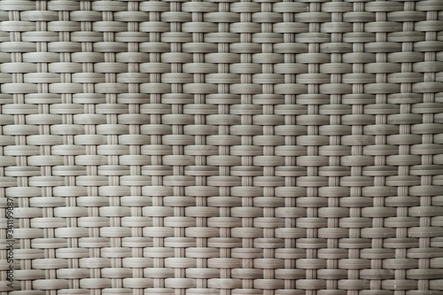 Abstract background of wicker stripes of matting. Texture and patterns handmade. Outdoor furniture close-up.