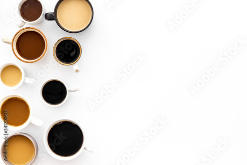Many cups of coffee on white table top-down copy space