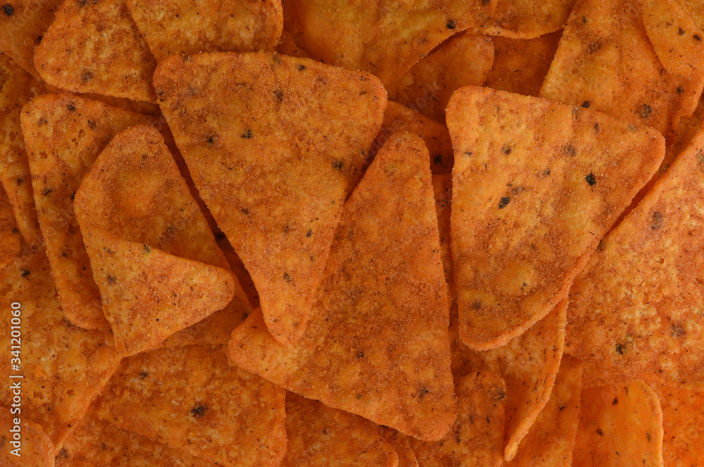 Nachos close up. Tortilla chips background. Mexican corn spicy chips macro top view.