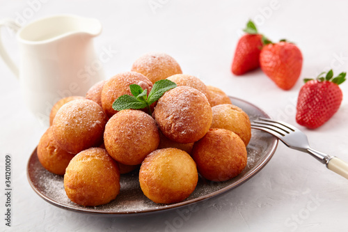 Beautiful breakfast. Cottage cheese donuts balls on a light background.