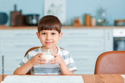 Little boy drinking milk in...