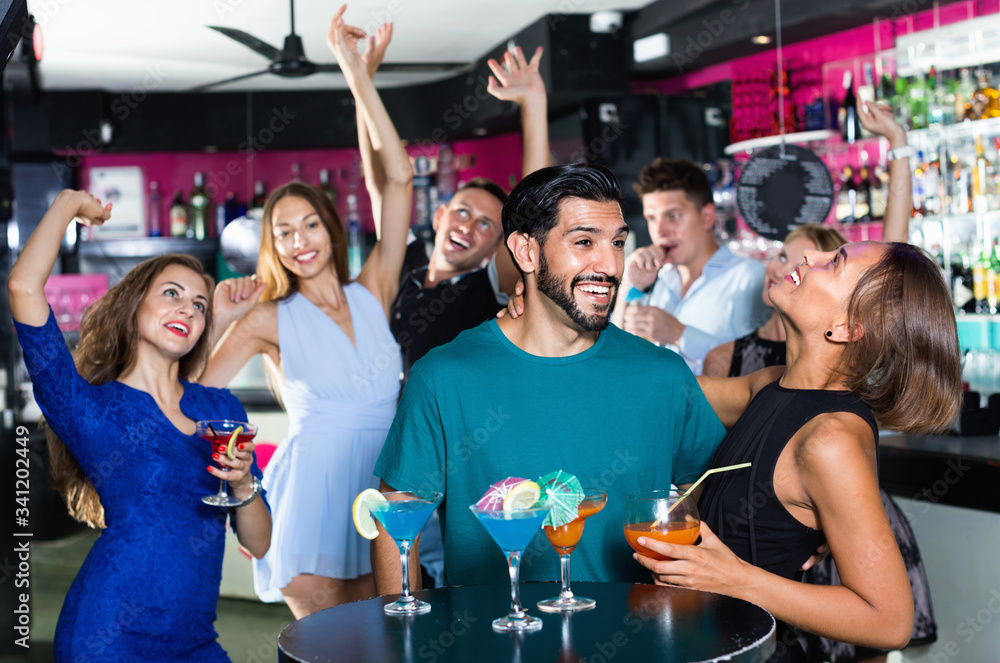 © JackF - Man with young female are enjoying the party in bar. © JackF - Man with young female are enjoying the party in bar.