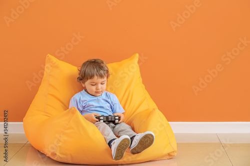 Cute little boy with game p...