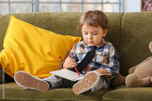 Cute little boy with notebo...