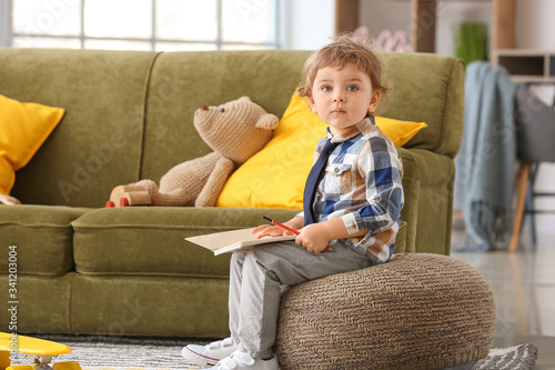 Cute little boy with notebo...