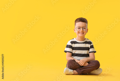 Cute little boy on color ba...