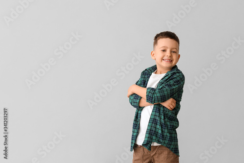 Cute little boy on grey bac...