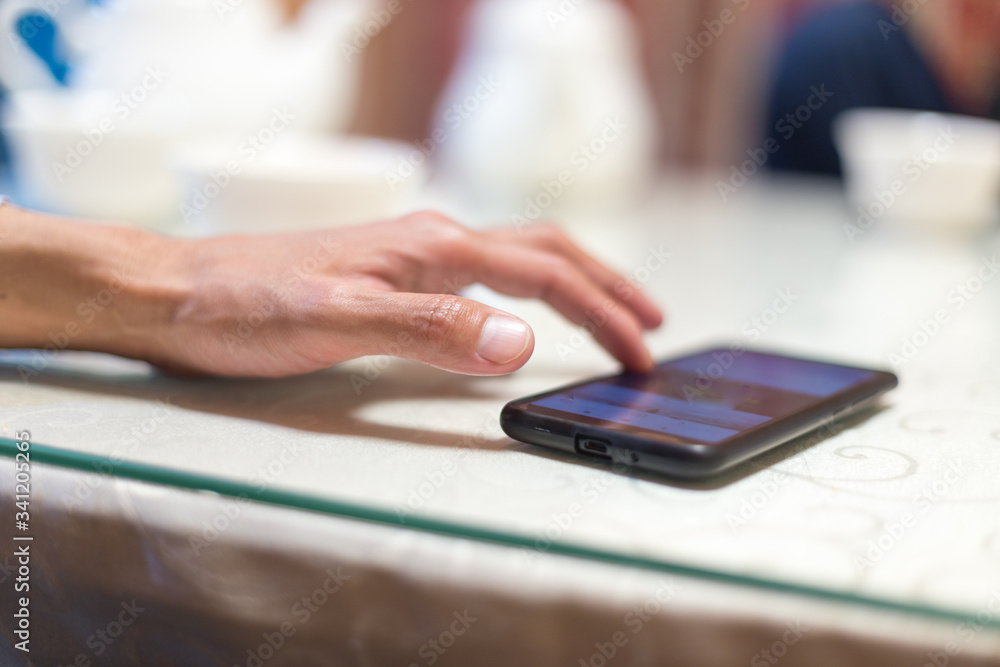 Fototapeta premium A man sits in a cafe and reads SMS