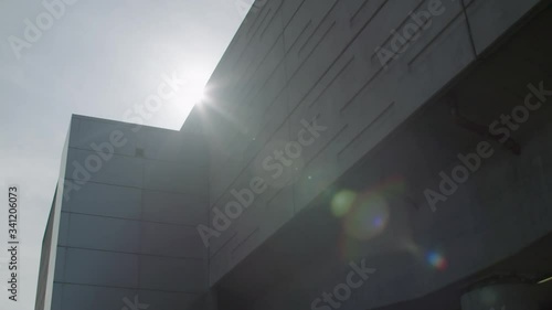Slow motion sun and lens flare over building