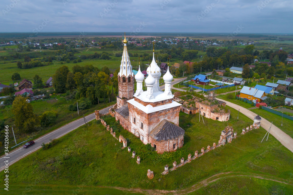 Intercession Church in a rural landscape on a September cloudy day (quadrocopter shot). The village of Dunilovo. Ivanovo region, Russia