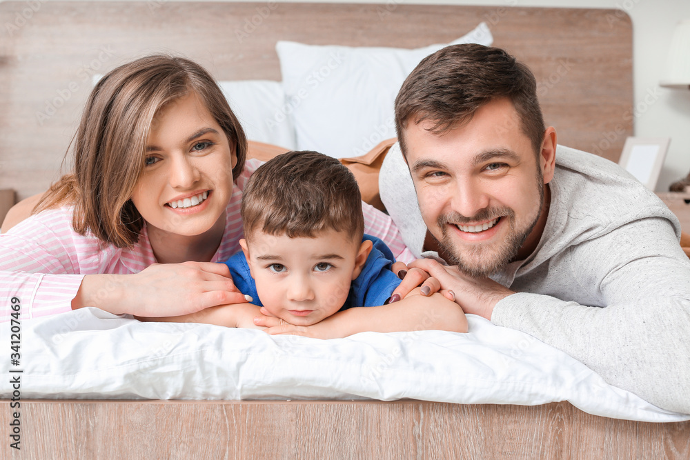 Portrait of happy family in bedroom