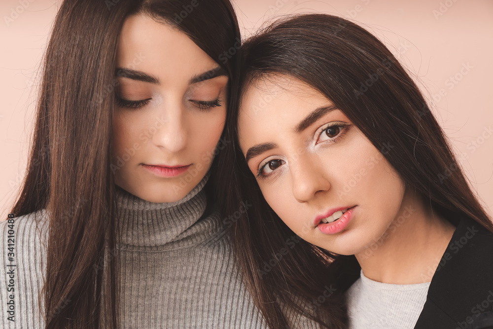Stylish young women on color background Stylish young women on color background