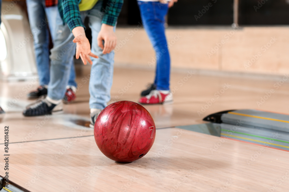 Fototapeta premium Little children playing bowling in club