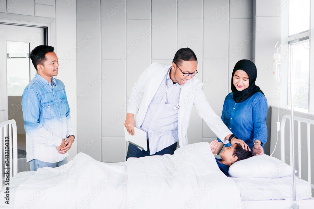 Male doctor checking his patient in hospital Male doctor checking his patient in hospital