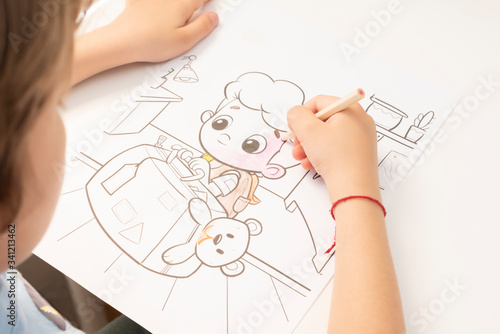 Child coloring drawing at home.