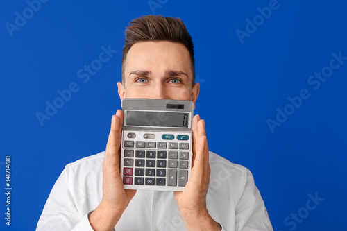Young man with calculator o...