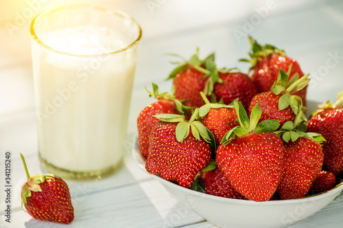 Ripe strawberries and a glass of milk. natural farm products.