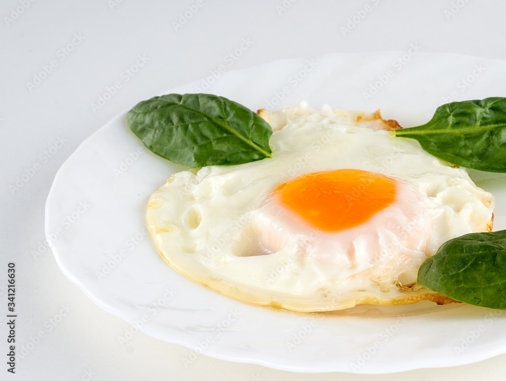 eggs with spinach on a white table eggs with spinach on a white table