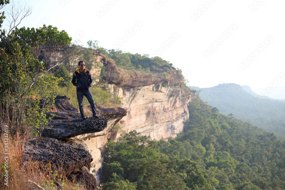 Man standing on the cliff at Pha Tam National Park, Ubon Ratchathani, Thailand
