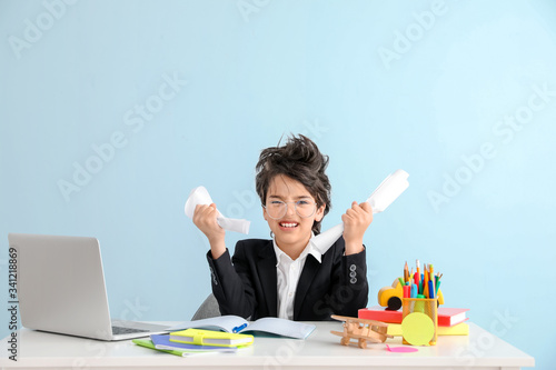 Stressed little boy doing h...