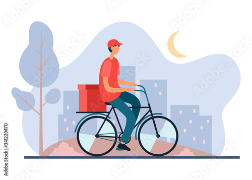 Delivery worker riding bicycle in city late at night