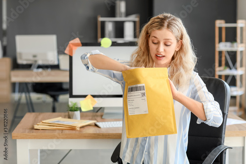 Young woman with letter in ...