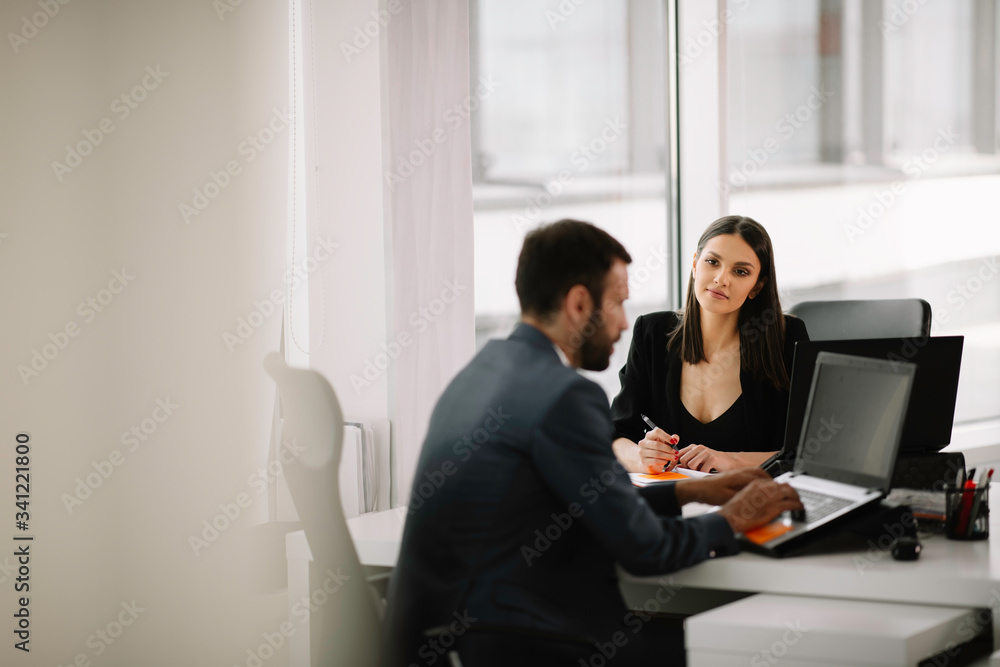 Colleagues working together at the office. Businessman and businesswoman preparing for the meeting. Colleagues working together at the office. Businessman and businesswoman preparing for the meeting.